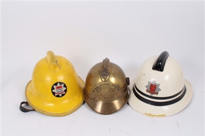 Lot 581 - French brass fire helmet, an Essex fire brigade helmet and a London fire brigade helmet (4)