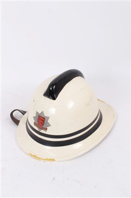 Lot 581 - French brass fire helmet, an Essex fire brigade helmet and a London fire brigade helmet (4)