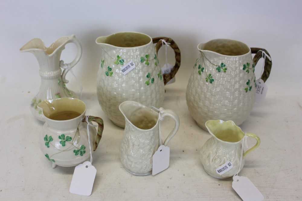 Lot 2001 - Group of six Belleek porcelain jugs