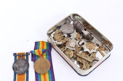 Lot 505 - First World War pair comprising War and Victory medals named to 14028. DVR. G. Stanhope. R.A. Together with cap badges