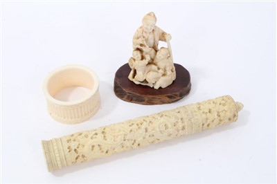 Lot 665 - Japanese ivory netsuke group, Cantonese ivory needle case and ivory napkin ring (3)