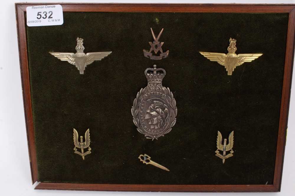 Lot 532 - Group of Special Forces cap badges, including SAS mounted on a board (7 badges)