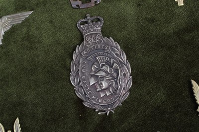 Lot 532 - Group of Special Forces cap badges, including SAS mounted on a board (7 badges)