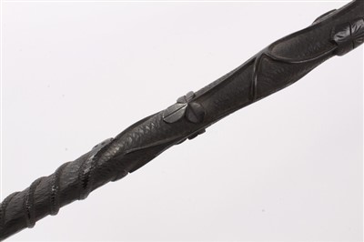 Lot 635 - Unusual Irish carved bog oak walking stick, 19th century patridgwood cane and another cane