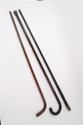 Lot 635 - Unusual Irish carved bog oak walking stick, 19th century patridgwood cane and another cane