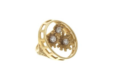 Lot 424 - 18ct gold oval openwork ring with three flowers, each set with a brilliant cut diamond