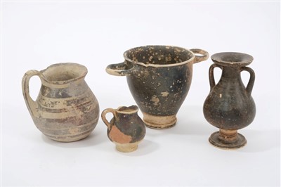 Lot 592 - Etruscan black glazed pottery urn, together with three other glazed Ancient Italian vessels.