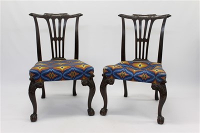 Lot 1352 - Elaborate pair of Chippendale-style side chairs, each with ornately carved vase splat back and embroidered stuffover seat on blind fret carved square supports