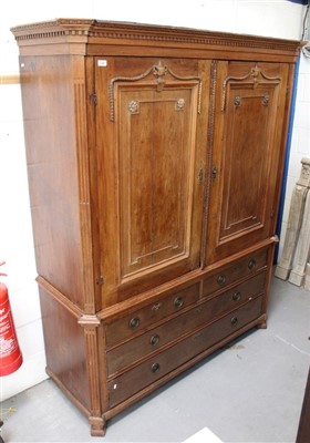 Lot 1355 - Late 18th / early 19th century Swedish linen press with dentil cornice and enclosed by pair of swag and urn carved panel doors between canted angles, the conforming base with two short over two lon...