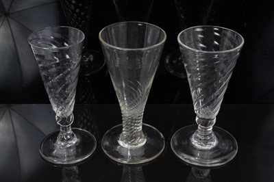 Lot 86 - Three Georgian wrythen ale flutes, a gilt decorated liqueur glass and a lace makers' lamp (5)