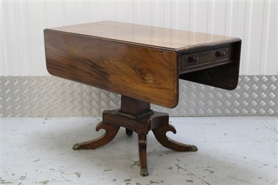 Lot 1044 - Regency mahogany Pembroke table with end drawer and opposing dummy drawer on square reel moulded column to the shaped platform with overscroll reeded quadruped supports on brass paw cappings 102cm