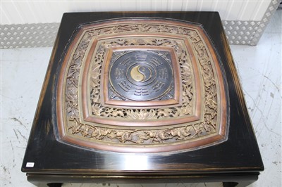 Lot 1405 - Large Chinese low table with relief carved inset pierced concentric panel on ebonised scroll legs 130cm square