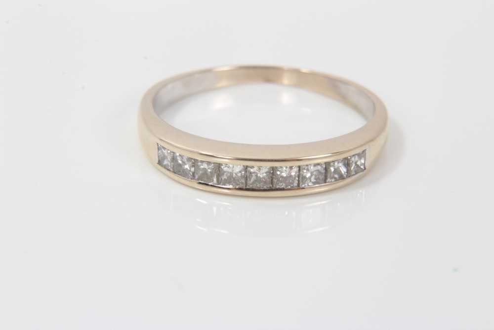 Lot 3228 - Gold (stamped 18k) diamond half eternity ring, with nine princess cut diamonds in channel setting, ring size O