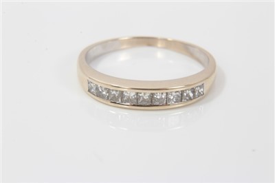 Lot 3228 - Gold (stamped 18k) diamond half eternity ring, with nine princess cut diamonds in channel setting, ring size O