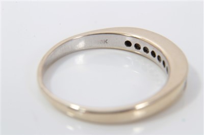 Lot 3228 - Gold (stamped 18k) diamond half eternity ring, with nine princess cut diamonds in channel setting, ring size O