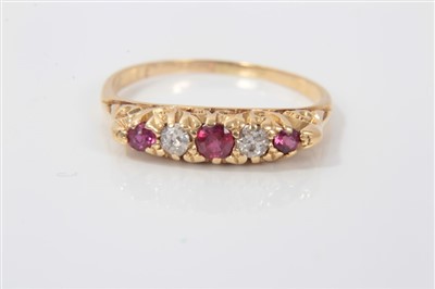 Lot 3233 - Diamond and ruby five stone ring with three round mixed cut rubies interspaced with two old cut diamonds, in gold claw and scroll design setting, ring size N½