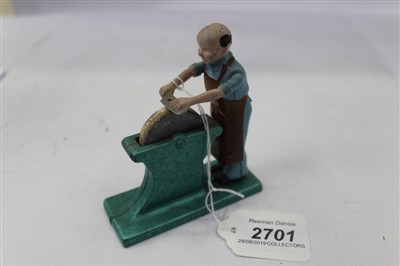 Lot 2701 - Small diecast model of a man sharpening a cleaver