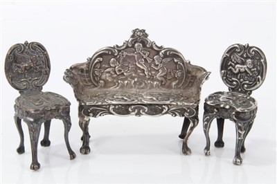 Lot 2728 - Suite of miniature silver salon furniture, by Levi & Salaman, Birmingham 1903 / 1904, comprising settee and two side chairs in the Rococo style, sette 4.5cm high