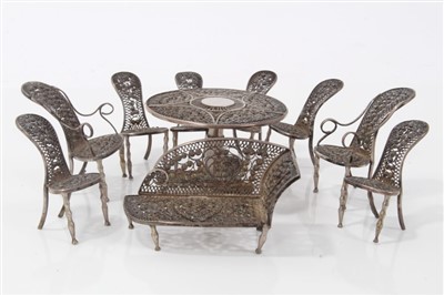 Lot 2732 - Impressive late 19th / early 20th century white metal suite of miniature filigree furniture comprising circular table, 5cm diameter, chaise longue, two armchairs, six side chairs. (10)