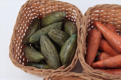 Lot 3775 - Collection of antique miniature painted ceramic vegetables, carrots, cauliflowers etc, presented in woven baskets