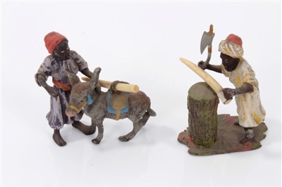 Lot 2738 - Pair of 19th century cold-painted metal figures of ivory traders, the tallest 5cm high