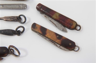 Lot 2739 - Collection of miniature penknives, each with folding blade, in bone or tortoiseshell, 2cm and smaller, together with miniature cutlery