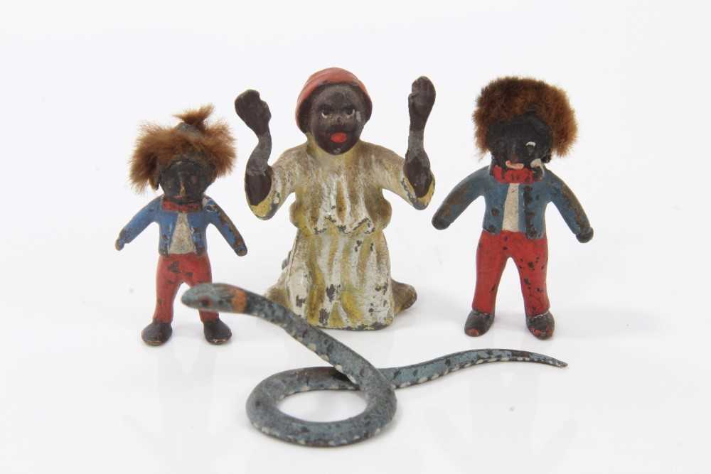 Lot 2743 - Two miniature cold painted bronze golliwog figures, the larger 3.5cm high, together with a cold painted metal; figure of a praying Arab