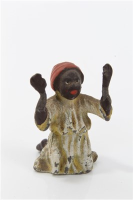 Lot 2743 - Two miniature cold painted bronze golliwog figures, the larger 3.5cm high, together with a cold painted metal; figure of a praying Arab