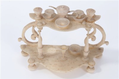 Lot 2744 - Finely carved antique bone miniature model of a credenze, fitted with tea set, 7cm wide