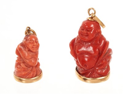 Lot 431 - Two gold mounted coral buddah figures