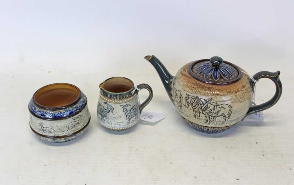 Lot 2008 - Doulton Lambeth Stoneware three piece tea set with sgraffito decoration with horses, goats and deer in landscape surrounded by glazed borders all signed Hannah Barlow (3)