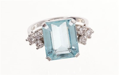 Lot 458 - Aquamarine and diamond ring with a rectangular step cut aquamarine flanked by six brilliant cut diamonds in platinum setting.