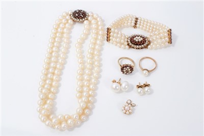 Lot 3340 - Cultured pearl three-strand necklace with gold, garnet and pearl clasp, matching bracelet, two similar dress rings and two pairs cultured pearl ear studs.