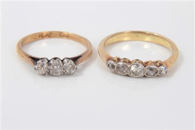 Lot 3341 - Diamond three stone ring and a diamond five stone ring (2).