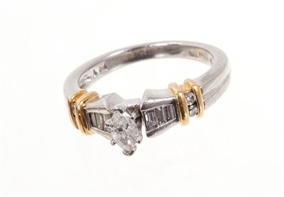 Lot 482 - Diamond and platinum ring with a marquise cut diamond flanked by graduated baguette cut diamonds in channel setting with four brilliant cut diamonds to the shoulders and applied yellow gold bands