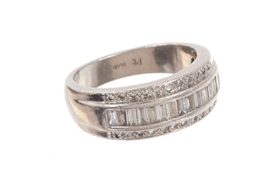 Lot 483 - Platinum and diamond ring with a wide band of baguette cut diamonds diamonds flanked by a border of brilliant cut diamonds in platinum setting