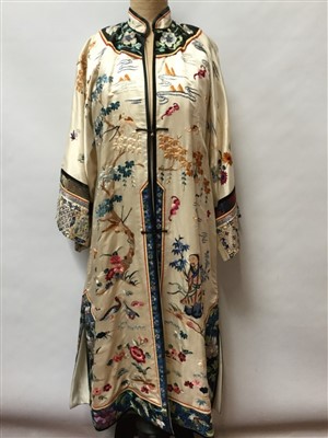 Lot 3070 - Chinese embroidered cream silk robe with figures, bats exotic birds, symbols in garden scene.