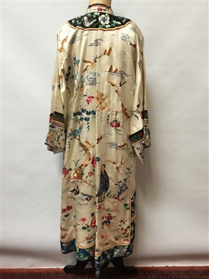Lot 3070 - Chinese embroidered cream silk robe with figures, bats exotic birds, symbols in garden scene.