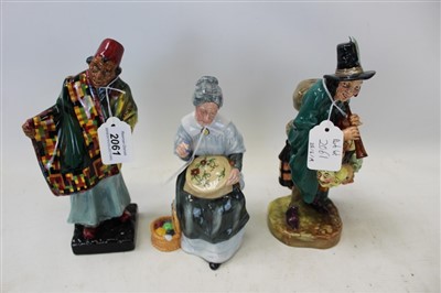 Lot 2061 - Three Royal Doulton figures - Carpet Seller HN1464, The Mask Seller HN2103 and Embroidering HN2855