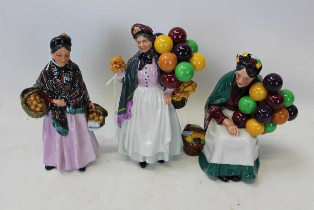 Lot 2062 - Three Royal Doulton figures - Biddy Pennyfarthing HN1843, The Old Balloon Seller HN1315 and The Orange Lady