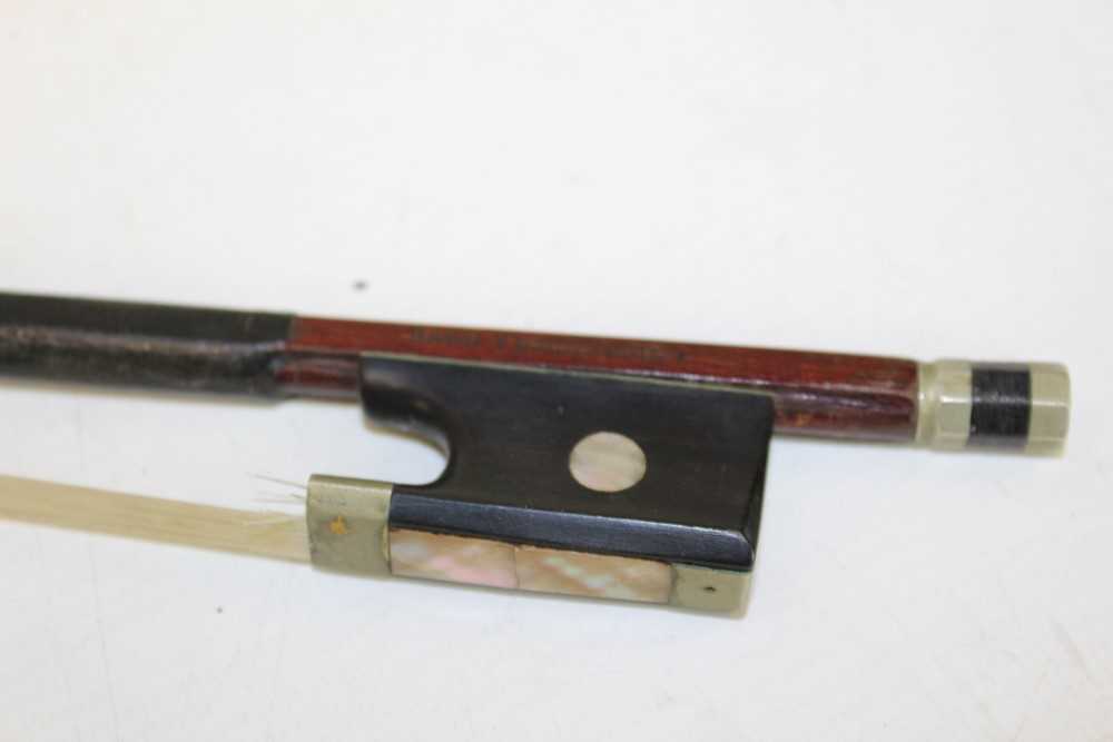 Lot 121 Antique violin bow, stamped Nach Vuillaume,