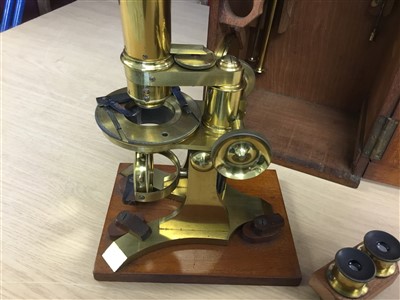 Lot 3525 - Good 19th century lacquered brass binocular microscope, probably by Ross of London, on tripod base and wooden stand, 33cm high, apparently unsigned but one lens case engraved Ross London, various a...