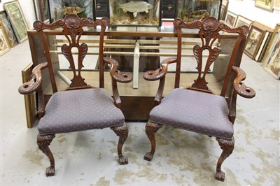 Lot 1384 - Pair of George II style mahogany elbow chairs, ornately carved with shell cresting and pierced plate back, scrolling pheonix carved arms and carved cabriole legs on paw feet