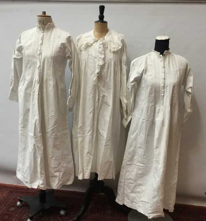 Lot 3079 - Quantity of Victorian and later babies clothing including white cotton and lace christening gowns, Liberty bodices, dresses, similar ladies long night dresses, two lace baby bonnets and two framed...