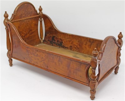 Lot 2770 - Late 19th/ Early 20th century Continental burr wood dolls crib with shaped head board and turned finials.