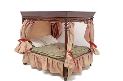 Lot 2771 - Victorian style doll's mahogany four poster bed with pink silk drapes and wood wool mattress