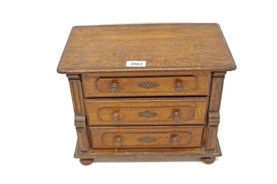 Lot 3563 - Edwardian oak miniature three-drawer chest on turned bun legs, 27cm overall height