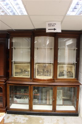 Lot 1397 - Late 19th / early 20th century mahogany shop display cabinet, the two height cabinet with central bowed section enclosed by three doors, the lower part with three glazed doors on plinth base