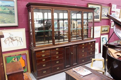 Lot 1398 - Large late 19th / early 20th century shop display cupboard, the upper glazed section with moulded cornice and enclosed by two pairs of doors, the base having central cupboard flanked by twin banks...