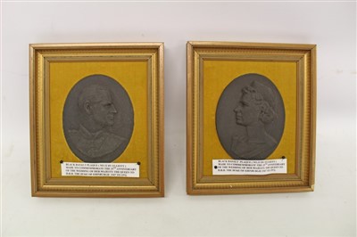 Lot 2079 - Pair of Black Basalt profile relief plaque by Elliot of Queen Elizabeth II and The Duke of Edinburgh, to commemorate their silver wedding, in gilt frames (2)